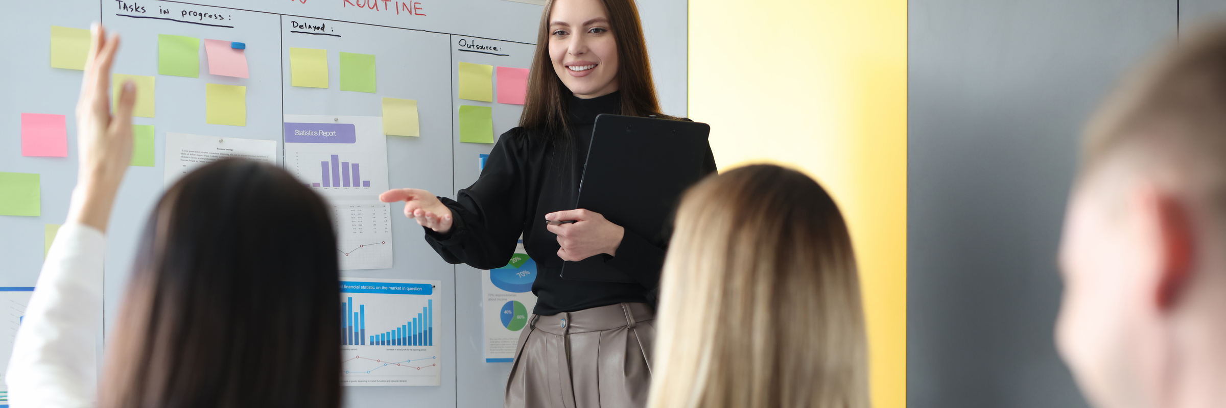 woman business coach standing near blackboard and asking question to listener
