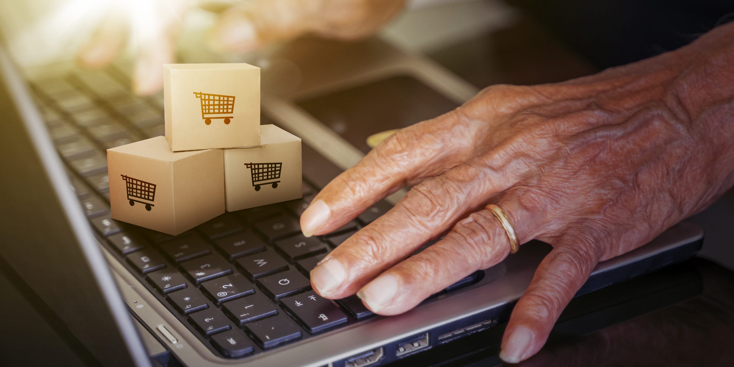 old man hands using a computer to shopping online