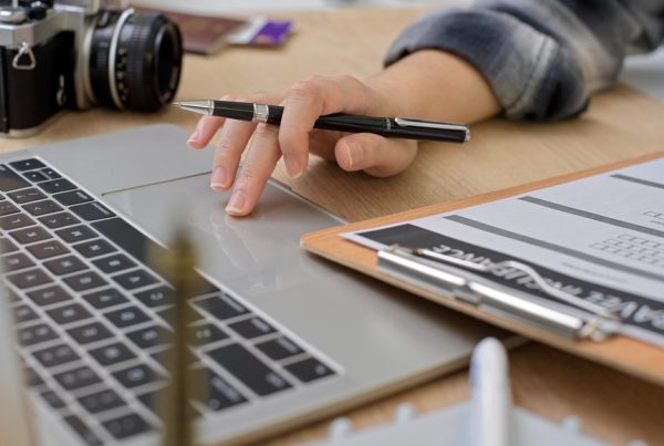 female preparing to travel, searching information for travel insurance on laptop