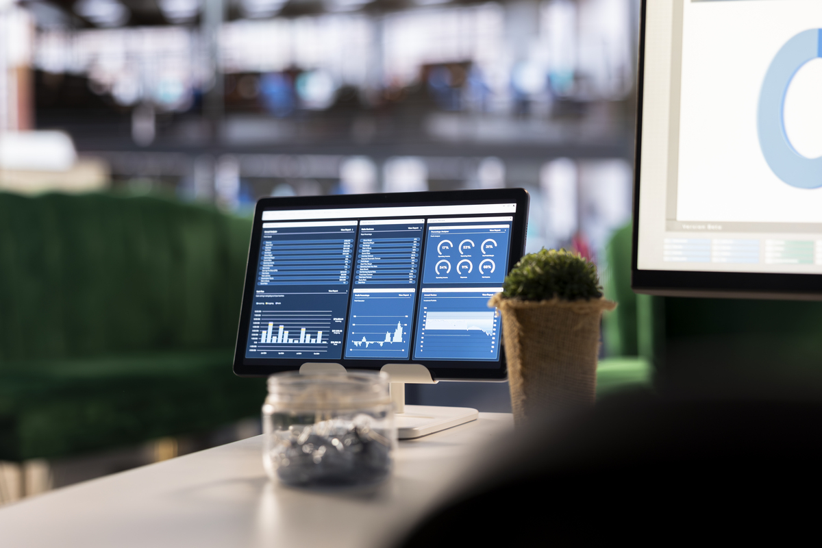 executive workspace features a digital dashboard with financial charts